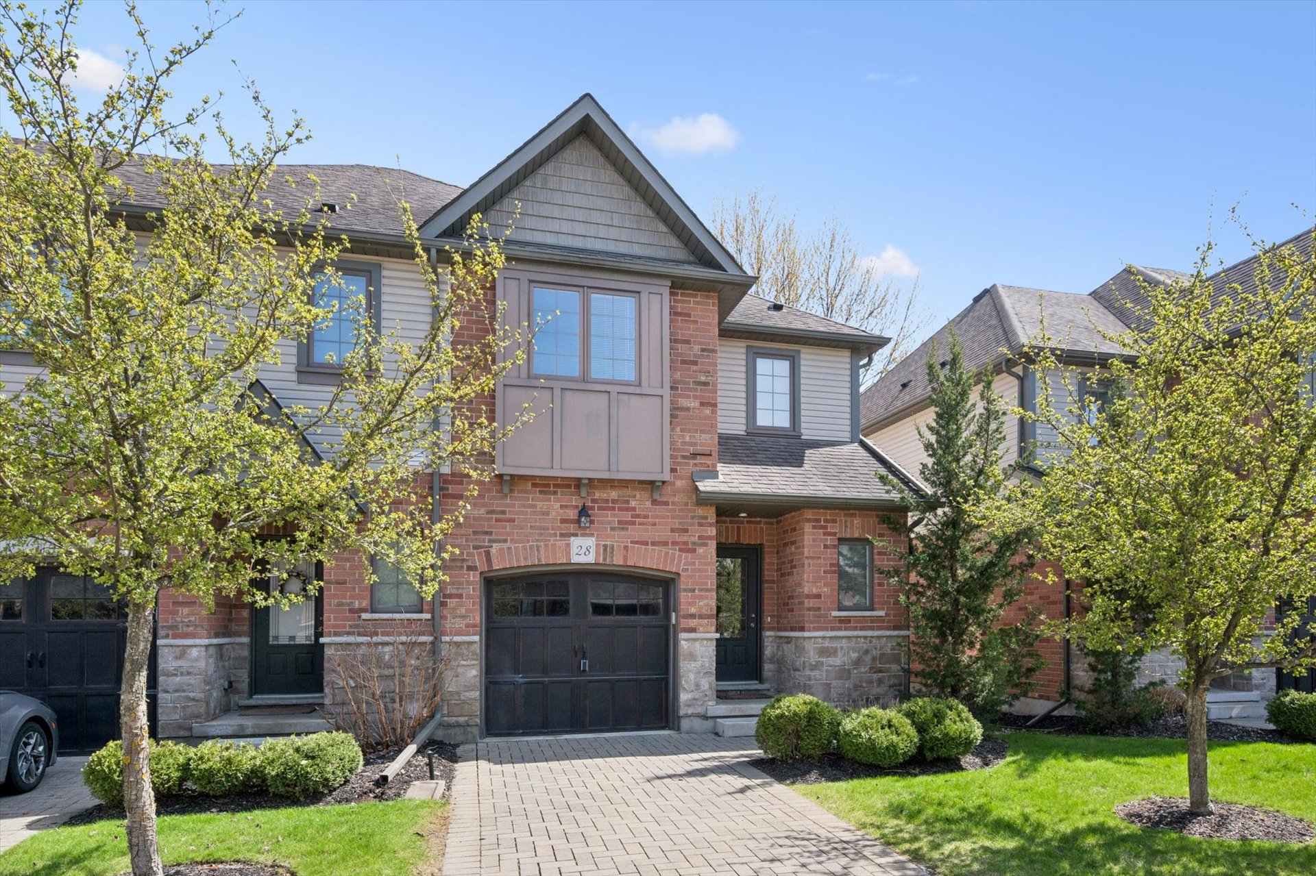 Front exterior of 28–146 Downey Road, a brick townhome in Kortright Hills, Guelph