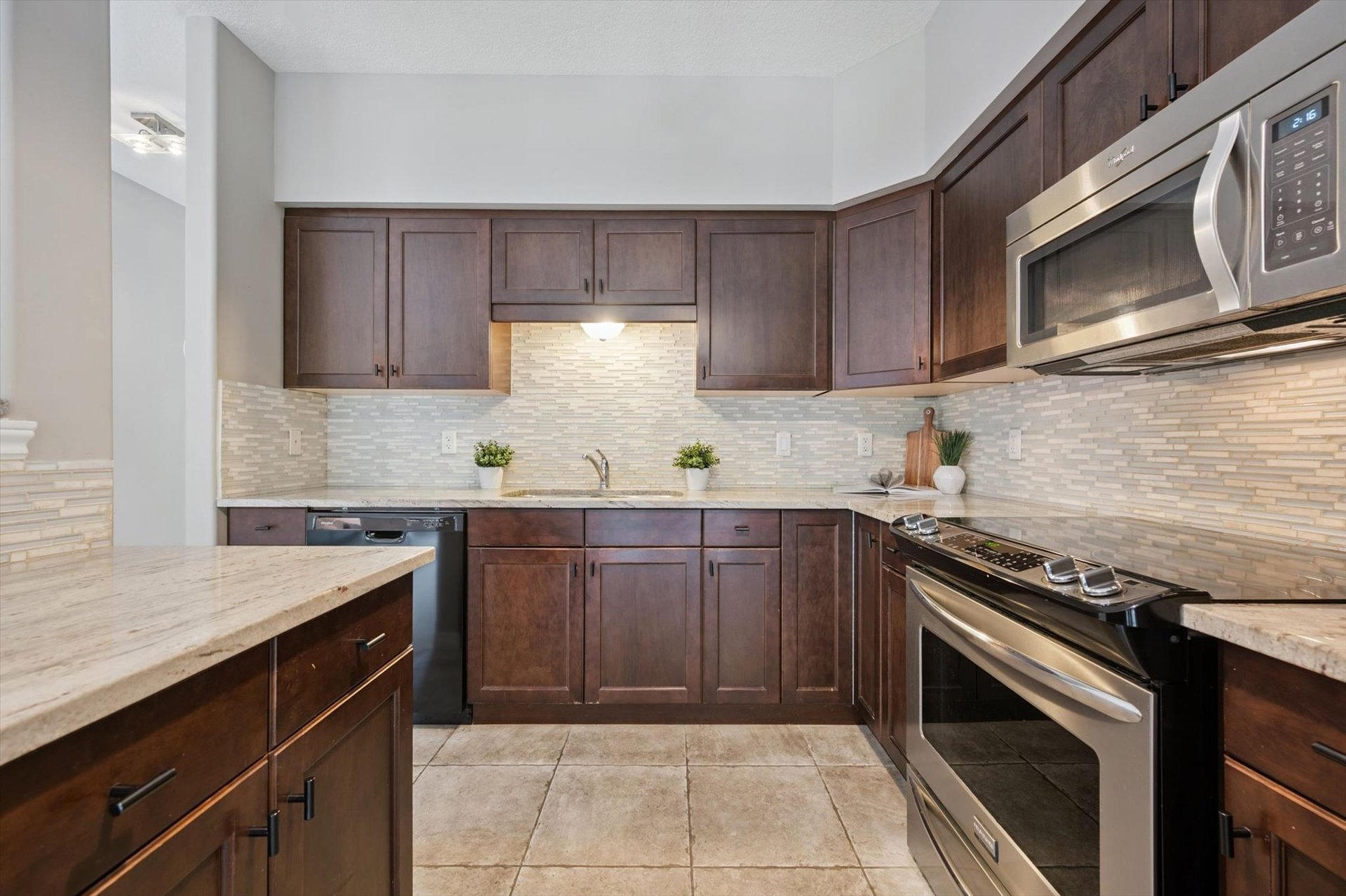 Kitchen with granite counters, tile backsplash and stainless steel appliances
